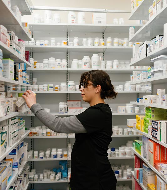 Pharmacy Tech pulling medication from shelf
