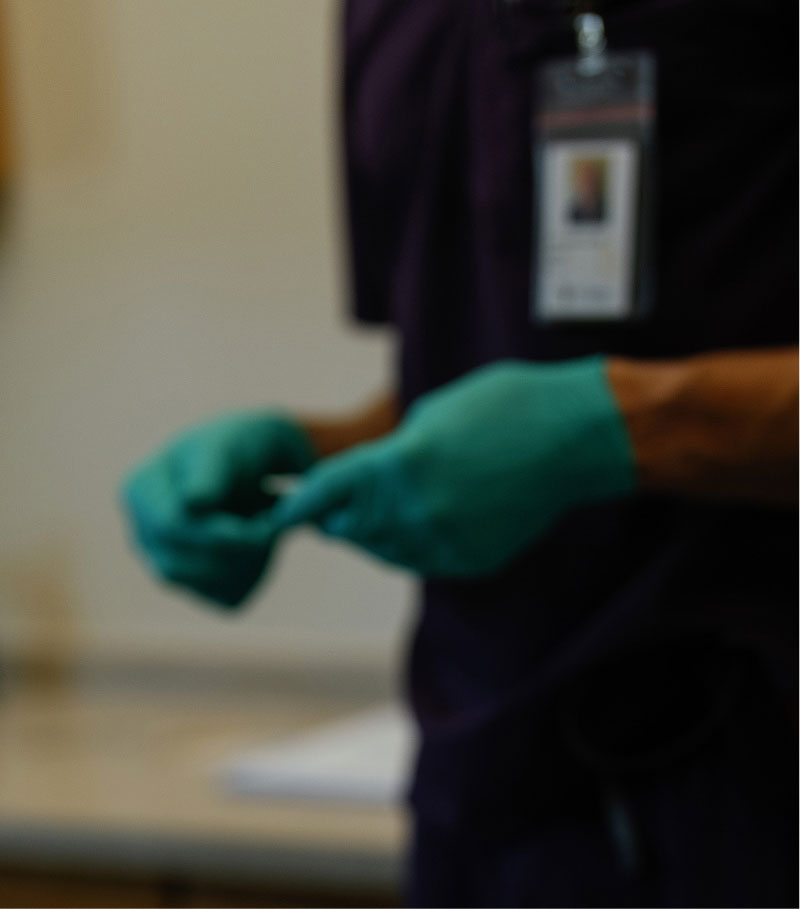Close up of medical gloves on employee