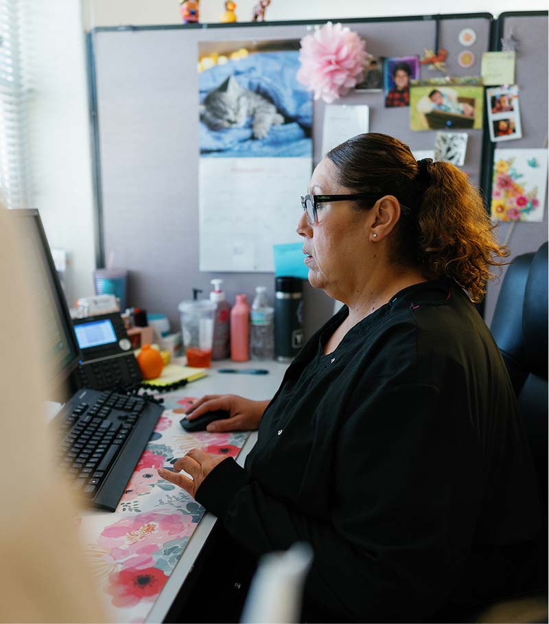 La Familia Staff member at desk