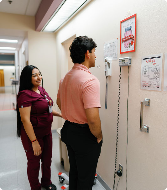 Patient getting weighed by medical staff