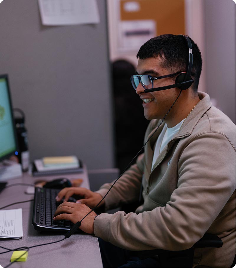 La Familia staff with headset at computer