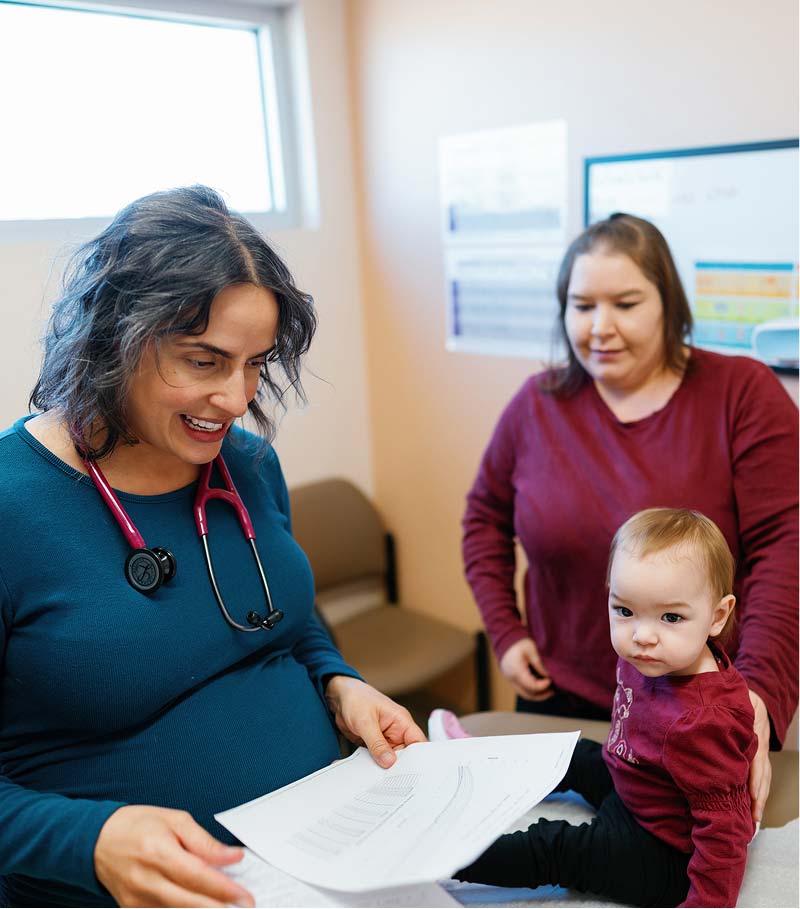 Doctor with patients at La Familia Health