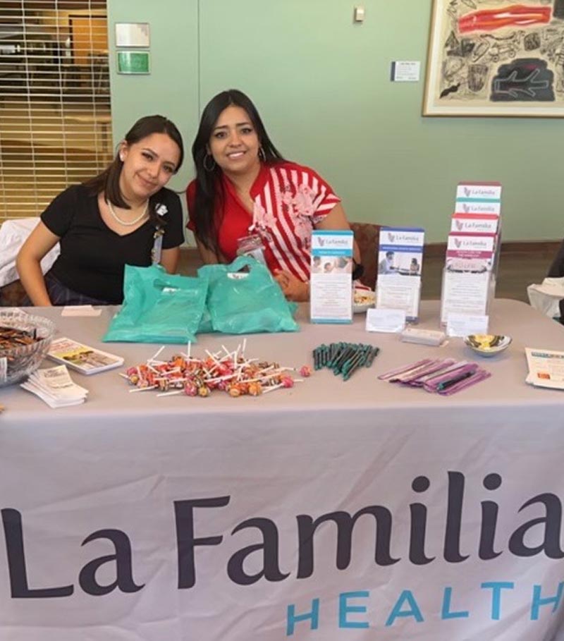 La Familia Employees behind La Familia Table at Event