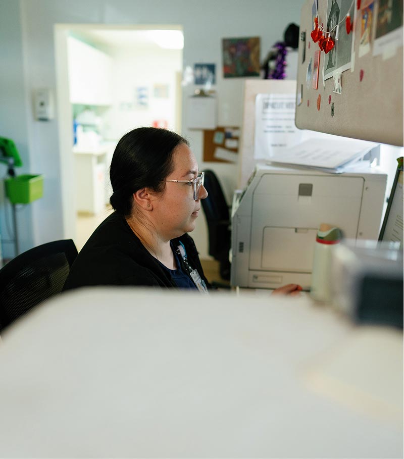 La Familia Staff member at desk
