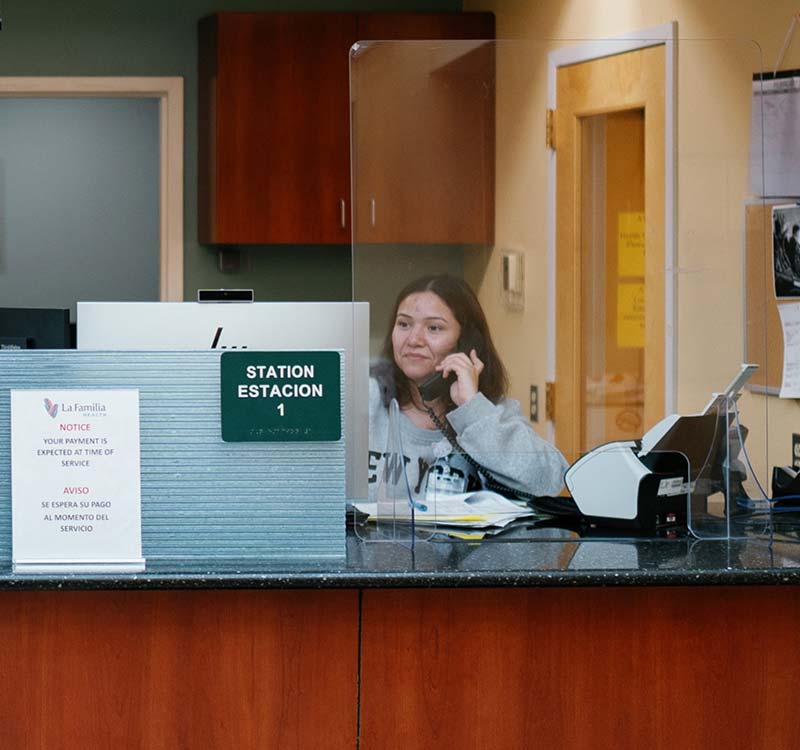 La Familia Staff Member at Reception Desk