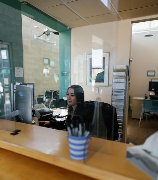 La Familia Health Employee at Desk