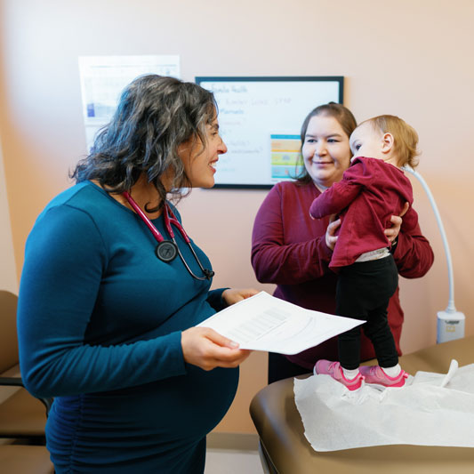 Doctor at La Familia Health with patients